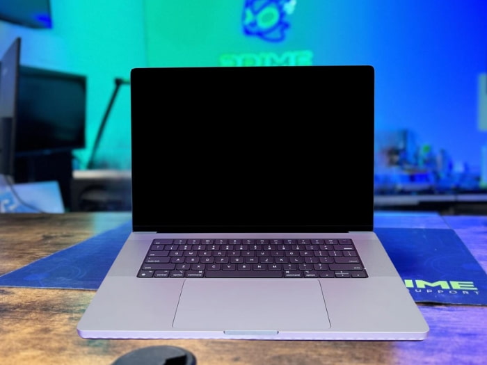 MacBook Pro displaying a black screen when fully opened.