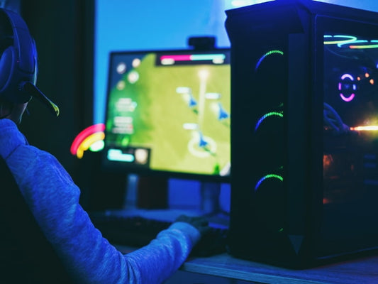 Gamer immersed in gameplay on his gaming PC.