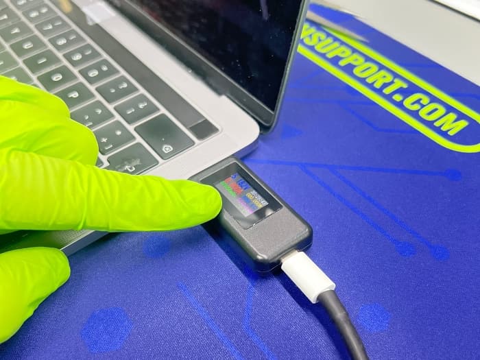 MacBook Pro with a non-functional charging port at Prime Tech Support for repair.