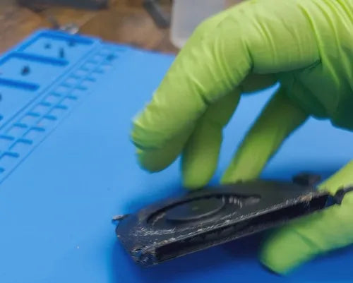 close-up of a technician's hands from Prime Tech Support in Miami, Florida, as they handle a fan component