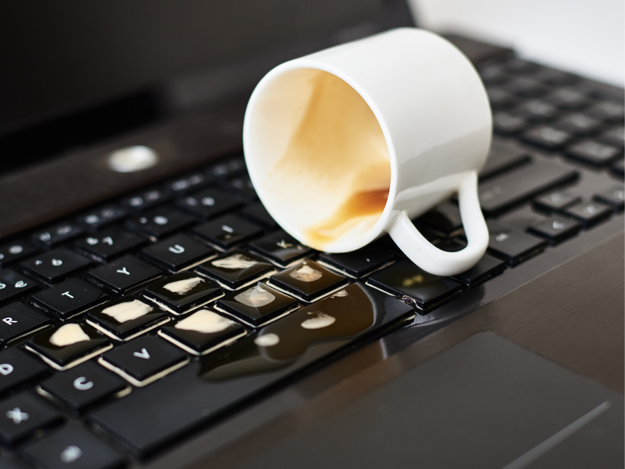 laptop liquid damaged of cup with water spilled on laptop keyboard