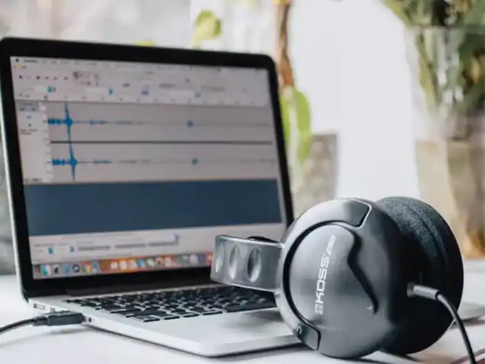 MacBook Pro user listening to music with their headphones after Prime Tech Support diagnosed and repair their audio issue in Miami