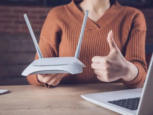 Person holding a WIFI router in Miami Dade County. Our Prime Technician will go to her location to quickly fix her network issues and get her back online to continue working.