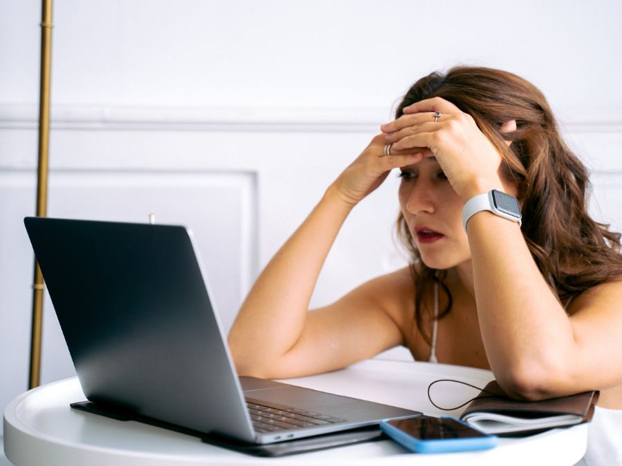 Woman frustrated because of data loss due to viruses. She reads Prime Tech Support blog to find solutions.
