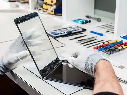 Prime Tech Support Technician repairing a tablet in our local store in Miami Dade County.