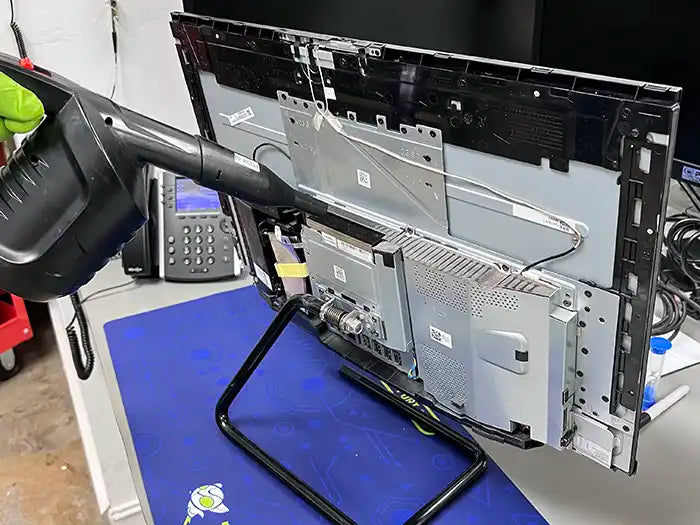 At the Prime Tech Support Lab in Miami, our technician carries out an All-in-One computer cleaning service. Using an air cleaning device, they ensure the unit remains free of dust, preventing overheating issues.