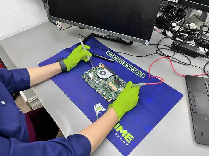 Prime Tech Support Technician using a voltage tester to diagnose and find the issue with the Motherboard of an All-in-One client located in Miami