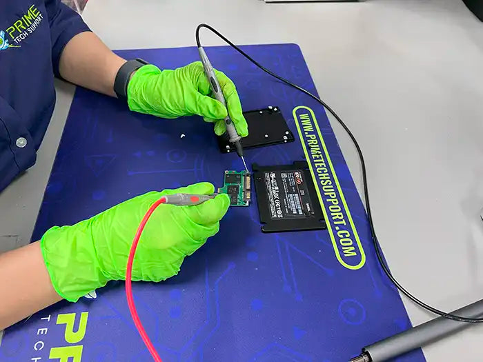 At Prime Tech Support's lab in Miami, a technician meticulously carries out a data recovery service for a customer's desktop. Using a a voltage tester to diagnose and retrieve the valuable data.