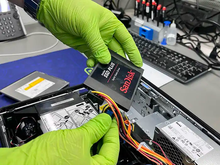 Prime Tech Support technician holding a SSD to perform a hard drive replacement for a customer's desktop computer located in Miami