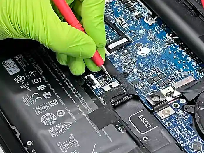 Prime Tech Support technician using a voltage tester to diagnose and repair a Gaming Laptop for a gamer customer located in Miami.