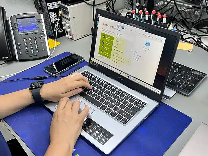 Prime Tech Support technician carrying out a software configuration service for a client's laptop in our lab located in Miami