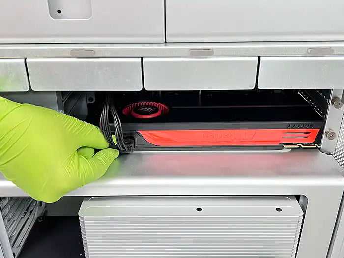 Prime Tech Support technician wearing green gloves while providing a Video and GPU repairs service for a Mac Pro customer located in  Miami