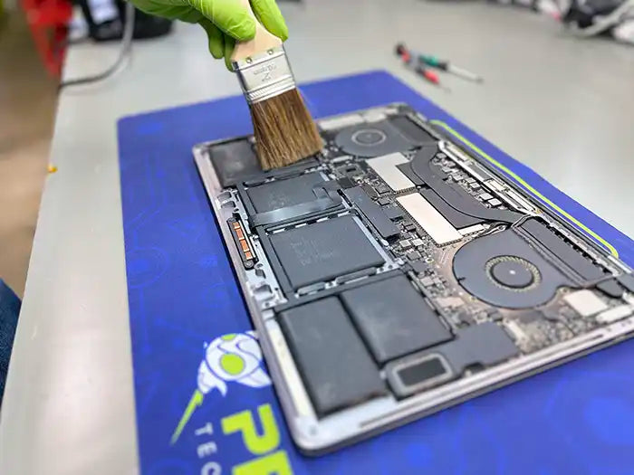 MacBook Pro computer cleaning performed at Prime Tech Support Lab in Miami. Our tech is using a air cleaning device to keep the unit free of dust to avoid overheating.