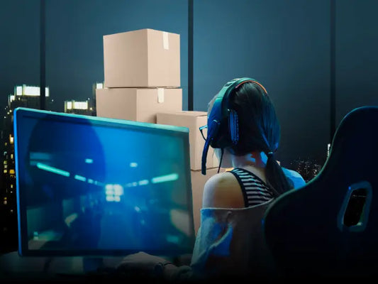 Gamer woman playing on her computer hours before starting to pack it to move.