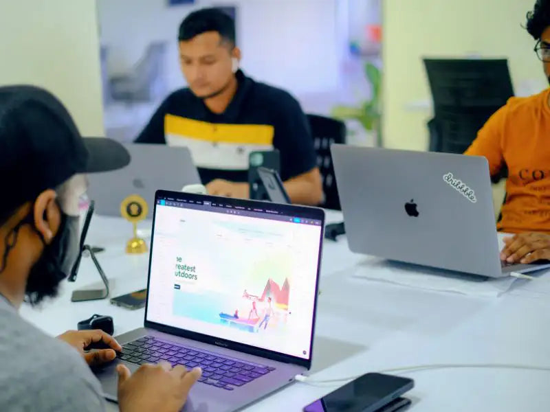 Company team working with their just fixed MacBook Pro devices. They received It Services from Prime Tech Support in Miami