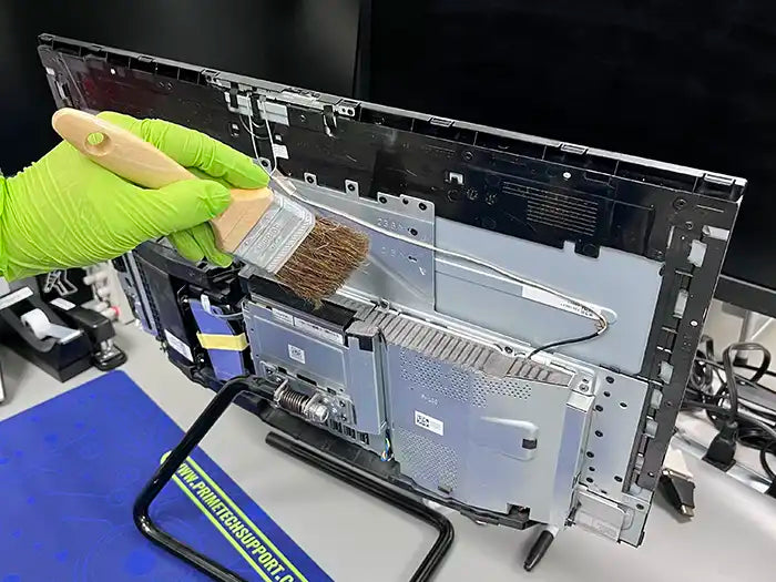 All in One computer cleaning performed at Prime Tech Support Lab in Miami. Our tech is using a air cleaning device to keep the unit free of dust to avoid overheating.