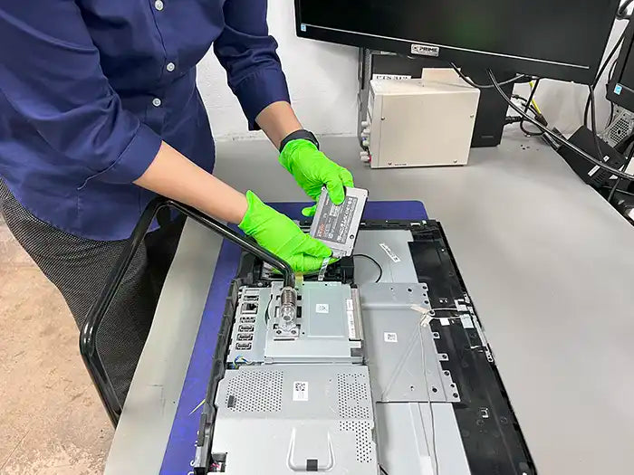 In the Prime Tech Support Lab located in Miami, a technician performs a hardware upgrade for a customer's All-in-One computer.