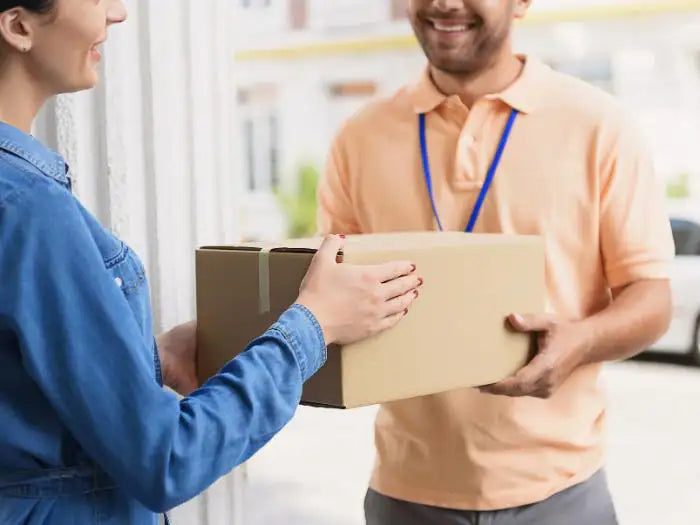 Delivery man picking up a computer from a customer located in Miami who want to have her computer repaired by our Prime Tech Support technicians