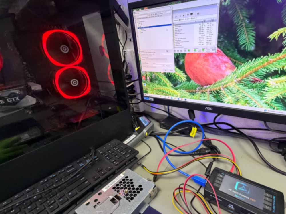 Data recovery workstation with professional tools connected to storage devices during data recovery analysis.