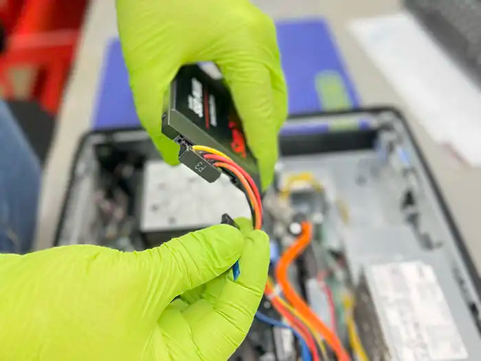 In Miami, a Prime Tech Support technician holds an SSD as they prepare to perform a hard drive replacement for a customer's desktop computer.