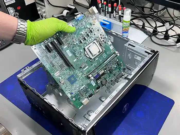 In Miami, a Prime Tech Support technician is diagnosing and repairing the Motherboard of a desktop computer for a customer.