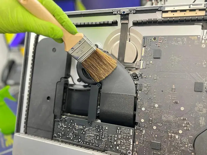 iMac computer cleaning performed at Prime Tech Support Lab in Miami. Our tech is using a air cleaning device to keep the unit free of dust to avoid overheating.
