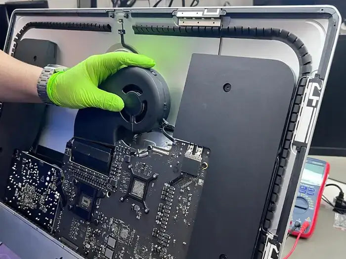 Prime Tech Support Technician performing an iMac Diagnostic where he examines in detail all the hardware and software aspect of the device to ensure an accurate repair afterwards.