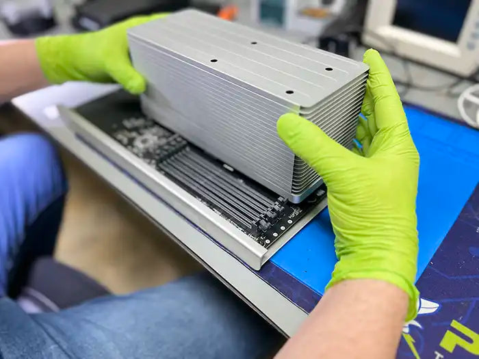 At Prime Tech Support's specialized lab in Miami, a technician wearing green gloves expertly carries out a hard drive replacement for a Mac Pro.