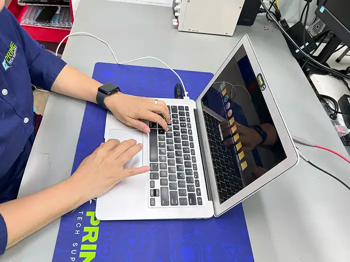 In Prime Tech Support's lab located in Miami, a technician performs MacBook Air software configuration to ensure optimal functionality.