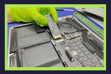 MacBook data recovery process in our Miami lab, showing a technician removing an SSD from the logic board