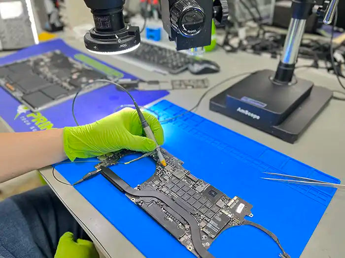 Logic board inspected and repaired by Prime Tech Support technician in our specialized lab located in Miami. He is testing the logic board and examining to find the issues with it and proceed to repair it.