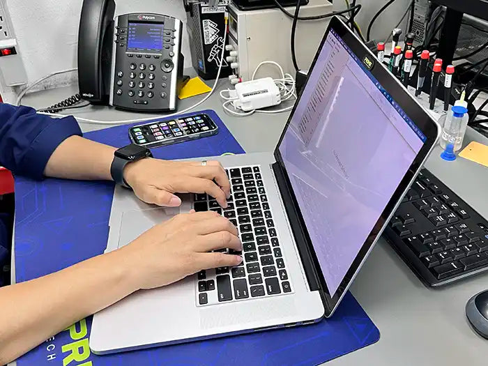 Prime Tech Support technician working on a MacBook Pro Software configuration service for a client in Miami