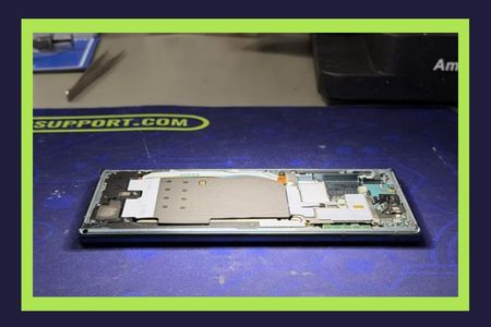 Disassembled smartphone during data recovery evaluation in our Miami lab, prepared for microscope inspection to identify a shorted component
